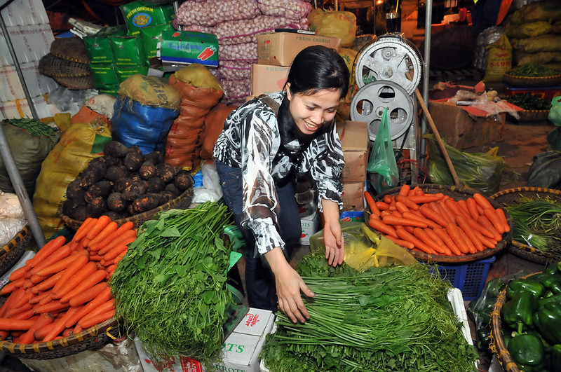 Woman arranging produce in a market