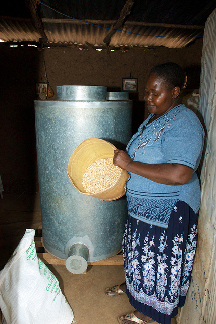 Esther Nduku in Embu, Kenya, stores clean, dry maize in a metal silo. Photo credit: CIMMYT.