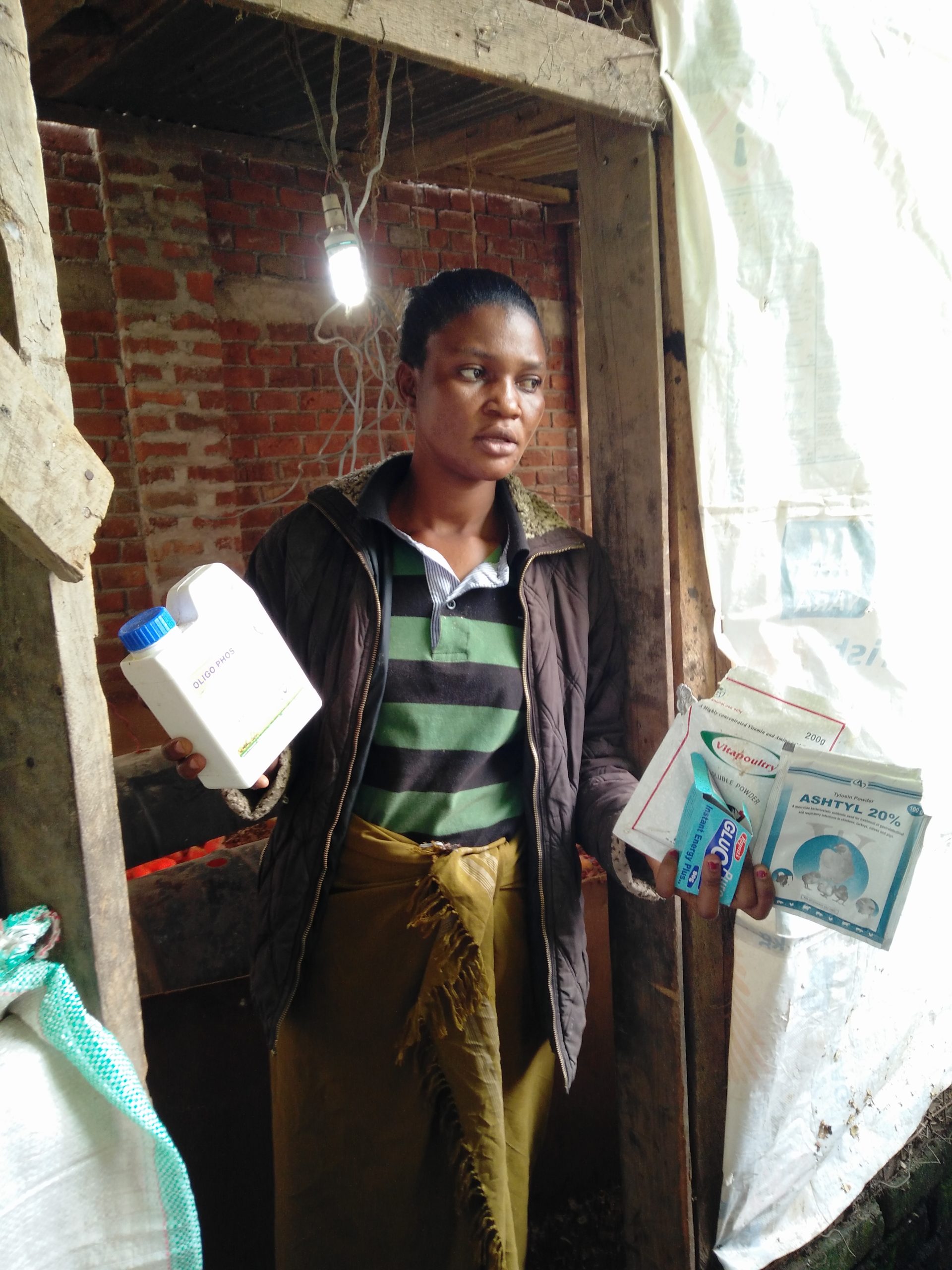 A female farmer shows antibiotics. Credit: Wim Goris / AgriProFocus 