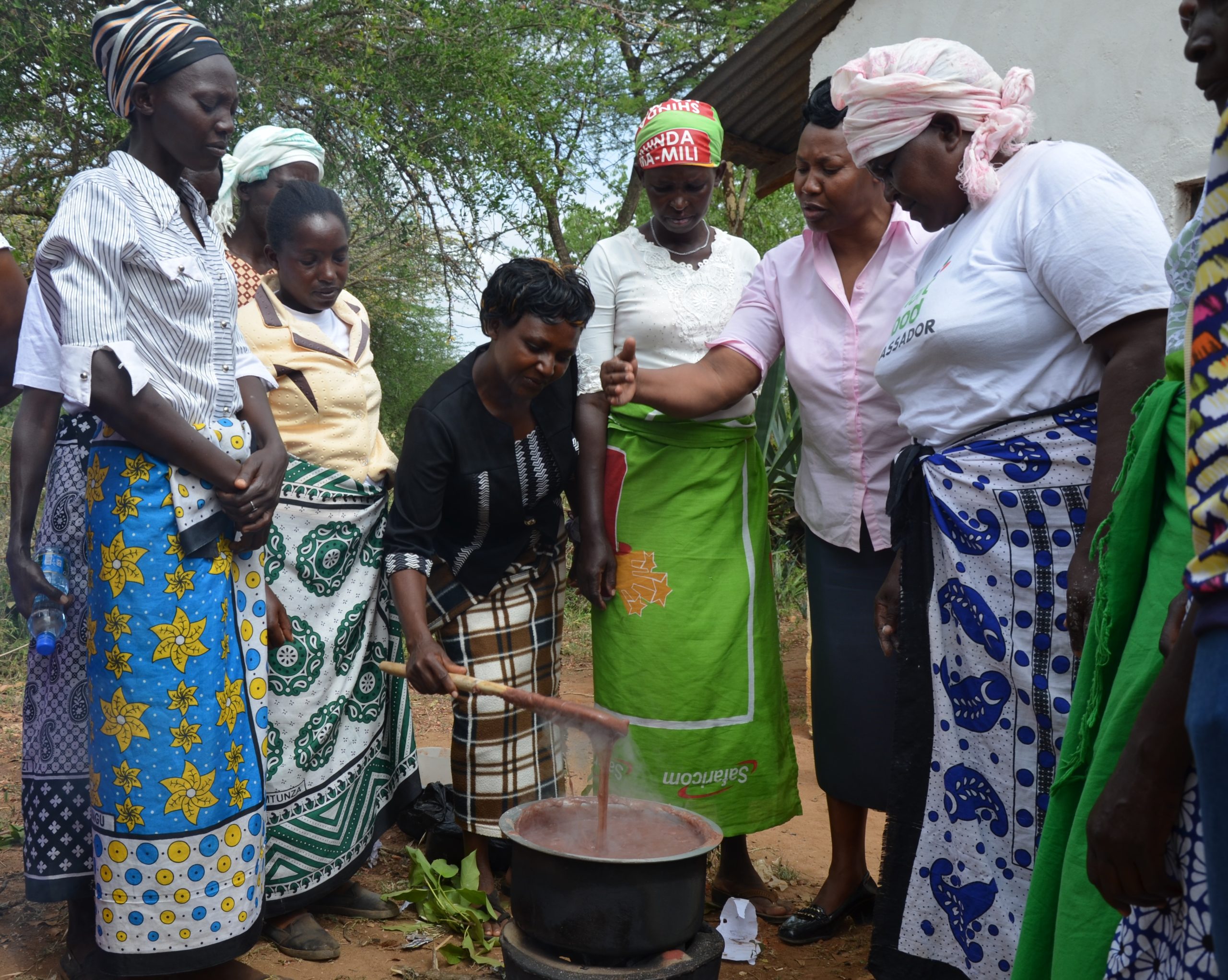 Rural Kenyan women learn a new way to cook finger millet porridge for better nutrition. Photo credit: Alina Paul-Bossuet