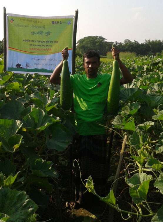 Farmer holding two large squashes