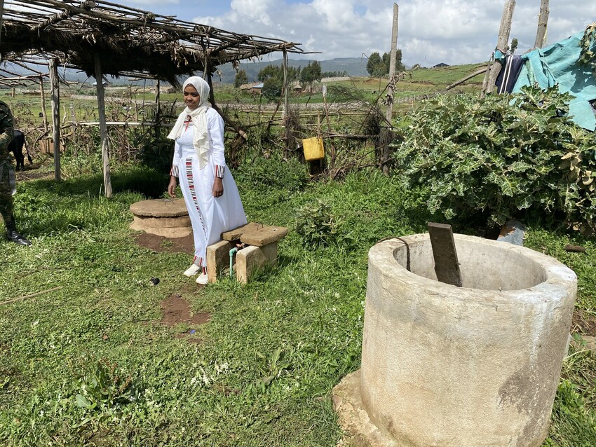 Farmer standing with biogas converter